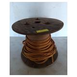 Wooden spool with yellow wire, 13x15 in