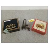 An old bike lock with keys, and two wooden cigar