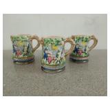 Three Majolica beer steins with people dancing,