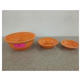 Three orange Fiesta bowls, the largest is 3.5 x9