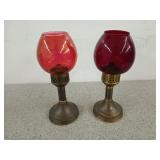 Two brass based candle holders with red glass