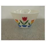 Beige Fire King mixing bowl with tulips on side,