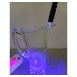 8 inch glass pitcher, faintly glows green under