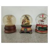 Three 5 and 1/2 in snow globes, two are