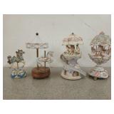 Four carousel music boxes, one is the romance of