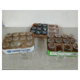 Assorted glass canning jars, most are 6 oz, many