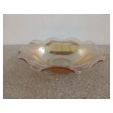 Peach colored carnival glass candy bowl with
