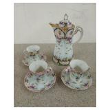 Beautiful old coffee pot with three cups and