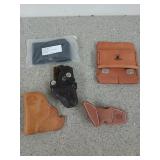 Five assorted gun holsters/coverings, four are