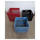 Three milk crates, one red one black and one blue