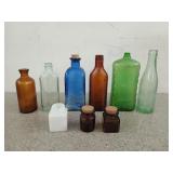 Collection of colored glass bottles, includes fish