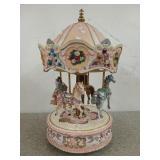 14 inch peach colored resin carousel with four