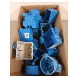 Box filled with assorted blue electrical outlet