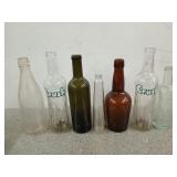Collection of seven glass bottles, two are