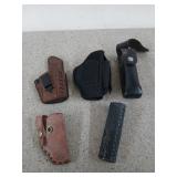 Assorted holsters, some are leather
