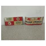 Two flattened oil cans, one is Texaco, one is