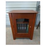 Wooden side table with glass door and two