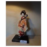 12' Orient al doll on wood stand