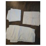 3 Assorted tablecloths with a plastic tote