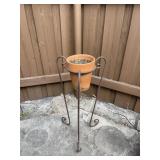 Wrought iron plant stand and clay pot wrought