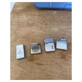 Four antique cigarette lighters