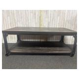 coffee table features a rustic wood-effect top and