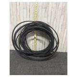 long, black rubber hose with brass fittings