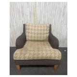 Outdoor accent chair featuring a rattan or wicker