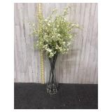 Floral arrangement in large glass vase