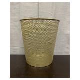 Gold-colored metal trash can