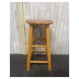 decorative wooden stool featuring a painted sun-li