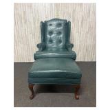 Queen Anne-style green leather wing-back armchair