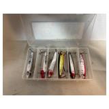 Assortment of fishing lures in case