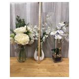 Three artificial flowers with vases
