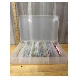 Clear tackle box with assorted fishing lures and s