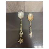 Pair of silver colored decorative spoons