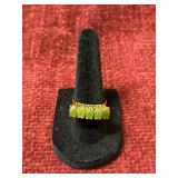 vintage-style 18K gold ring with five oval-cut gre