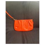 vibrant orange Coach leather wristlet
