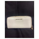 cream-colored Michael Kors zip-around wallet