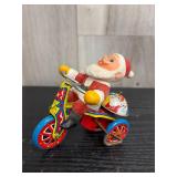 Mechanical wind-up toy Santa Claus on a bike