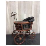 Victorian-style doll carriage with woven wicker bo