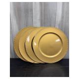 Set of 4 gold-colored plate chargers