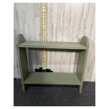 sage-green two-tier wooden shelf