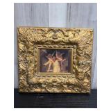 Gold-toned ornate framed angel print