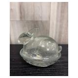 Clear glass bunny-on-a-nest candy dish featuring a