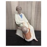 Porcelain figurine of a seated mother and a child,