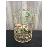 Vintage metal birdcage with pink bird