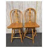 pair of light oak wooden swivel bar stools