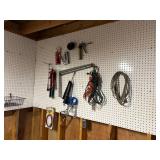 Contents of wall. Cords, Stapler, Grease Gun etc