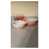 2 pink and white Pyrex mixing bowls and two